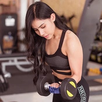 A woman lifting weights in the gym