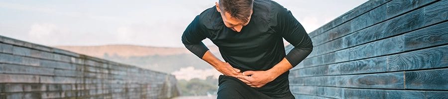 Man having side effects while jogging outdoors