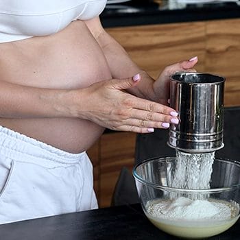 Pregnant mother making shake using protein powder