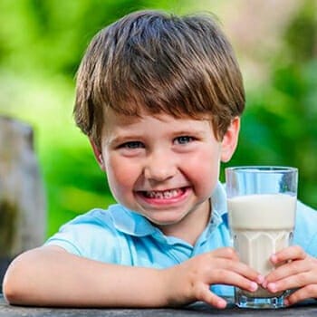 Boy holding Glass of Protein