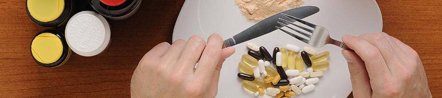 man with knife and fork, pre workout supplements on plate, jars