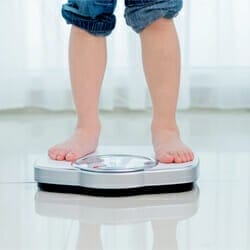 kid on weighing scale