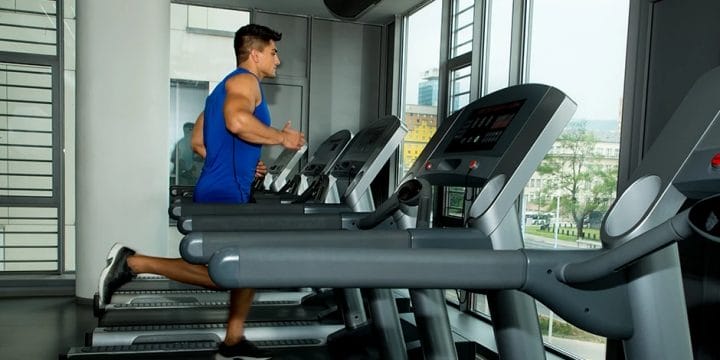 A man doing cardio using a compact treadmill