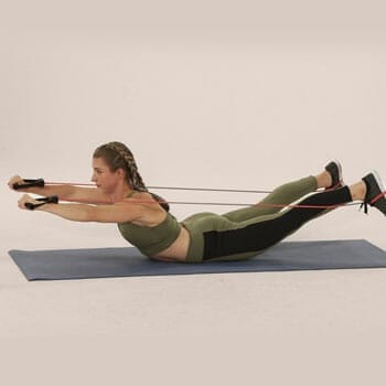 woman doing a superman workout with resistance band