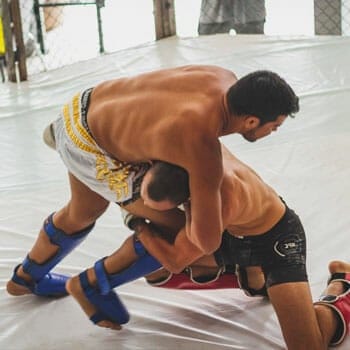 men fighting in a ring