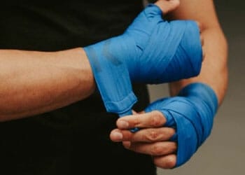 man fitting his boxing gloves