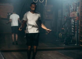 man working out using a jump rope