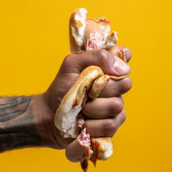 squeezed hotdog in a bun