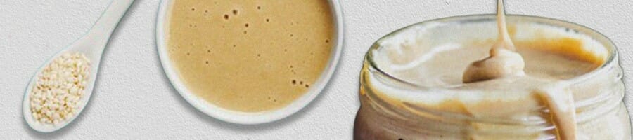 tahini on spoon, bowl and a jar