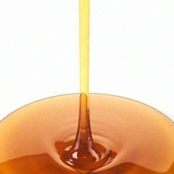 Maple syrup being poured in a flat surface