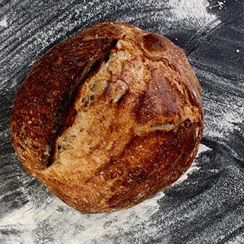 Sourdough bread with flour surrounding it