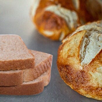 A sourdough beside a regular bread
