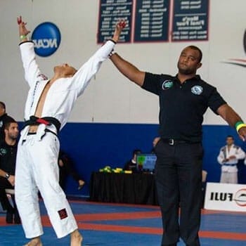 man raising a winners arm