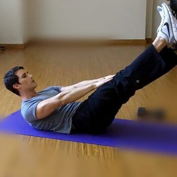 man laying down in a yoga mat doing V ups
