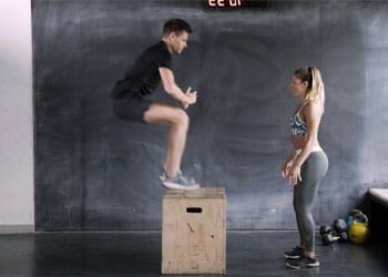 man working out while a woman watches