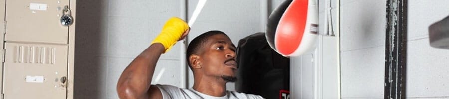 black man punching a speed bag