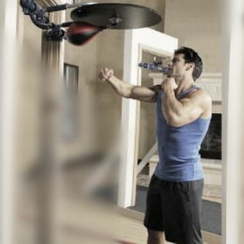 man working out with a speed bag at home