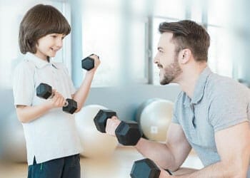man with his son inside a gym