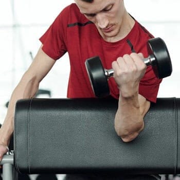 man using dumbbells in one arm
