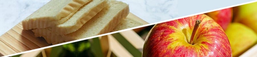 wheat bread on a chopping board, fresh apple from a basket