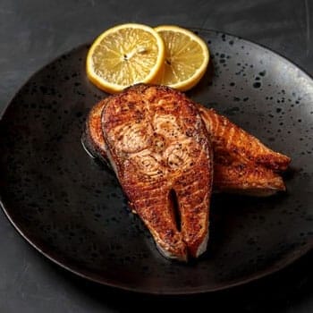 black plate with grilled salmon
