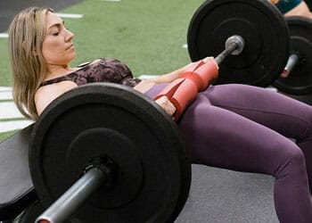 woman with a barbell on her waist