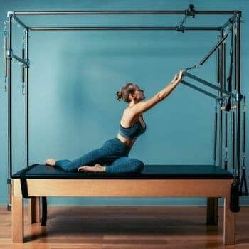 woman working out using pilates machine