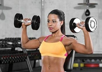 woman holding dumbbells in both hands
