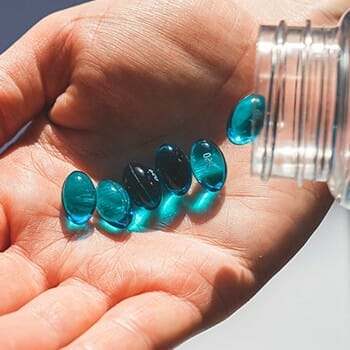 Supplements pouring on hand