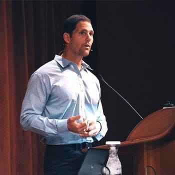dominic d'agostino giving a speech in a podium