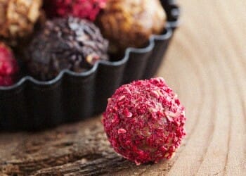 Dark Chocolate Strawberry Truffles on a wooden surface