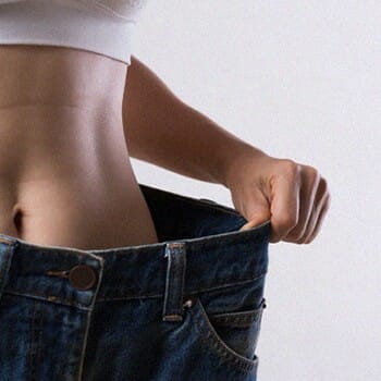 A woman inside an oversized jeans
