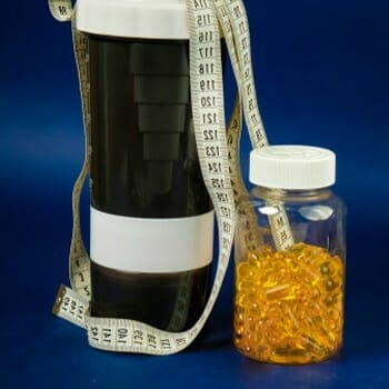measuring tape, jar of pills and a water jug
