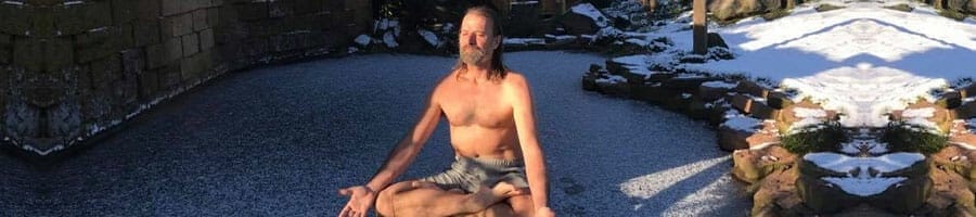 Wim Hof meditating in a yard