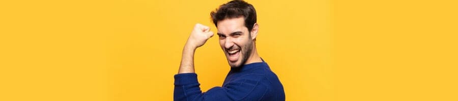 man smiling with his one arm flexing