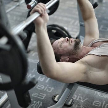 bearded man working out on a bench