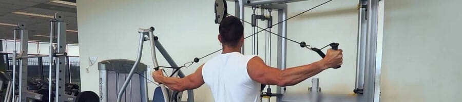 man working out using the cable machine
