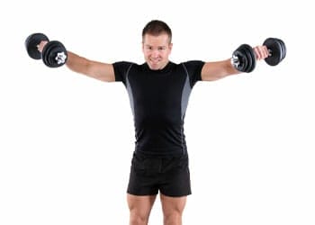 man in gym clothes raising dumbbells on both hands