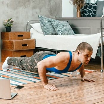 man in a push up position at home