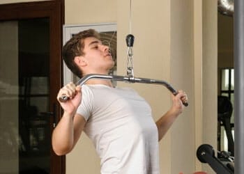 young man doing a lat pulldown