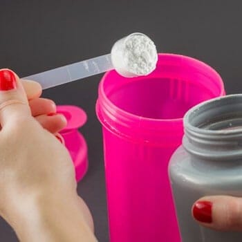 pink tumbler scooping powder
