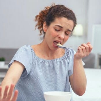 woman eating food in the kitchen
