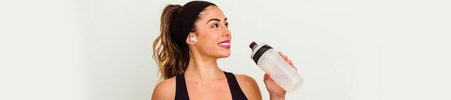woman smiling while holding a jug of water