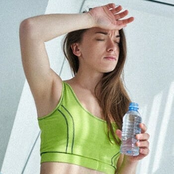 A woman dehydrated holding a water
