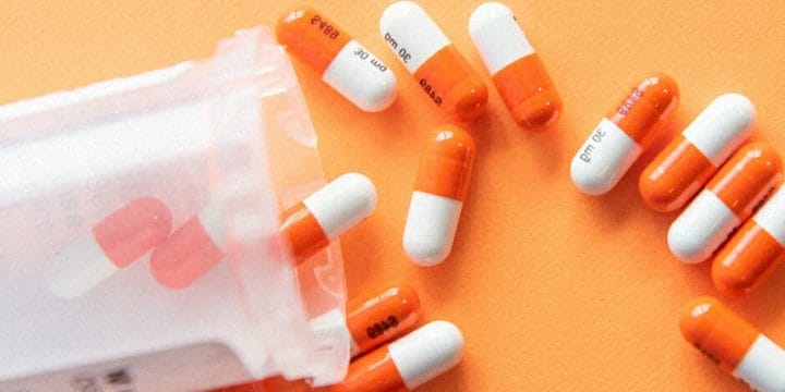 Spilled supplements on orange background