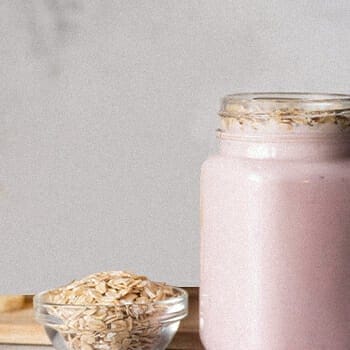 A strawberry smoothie with an oatmeal on top
