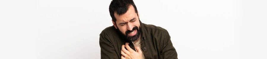 bearded man experiencing chest pains