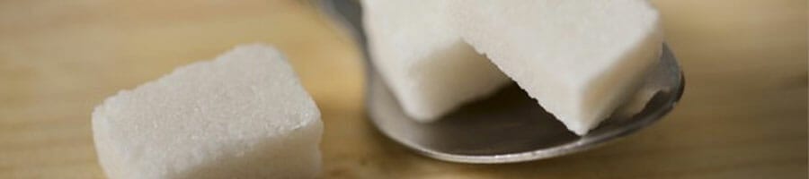 spoon filled with sugar cubes