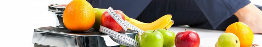fruits and measuring tape on a weighing scale
