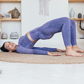 A woman doing the glute bridge exercise